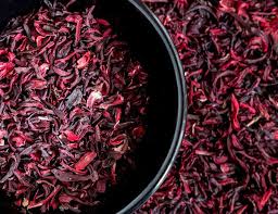 Dried hibiscus leaves for making zobo or bissap, a vibrant antioxidant-rich African drink.