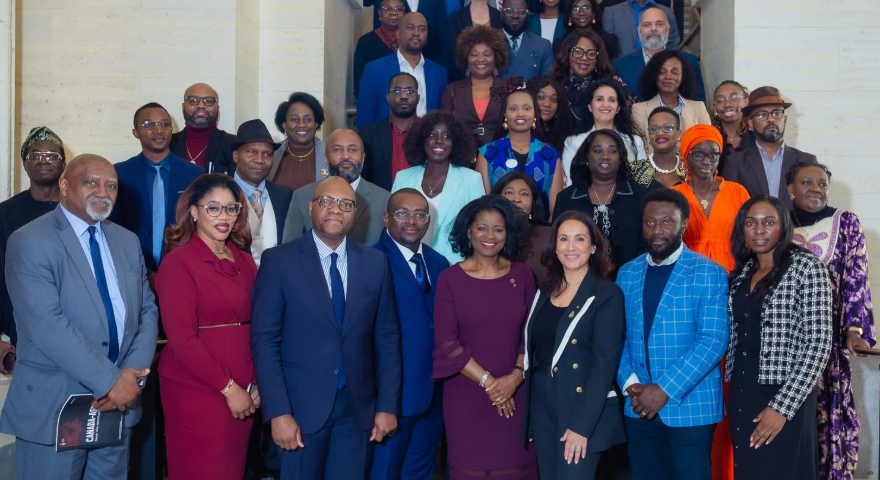 A wide-angle professional group portrait of the Pan-Canadian African Diaspora Congress founding committee inside the Senate of Canada. The diverse board members, including Chair Souad Elmallem and Vice-Chair Dr. Edward Akuffo, are smiling together in business attire to mark the official launch of the council.